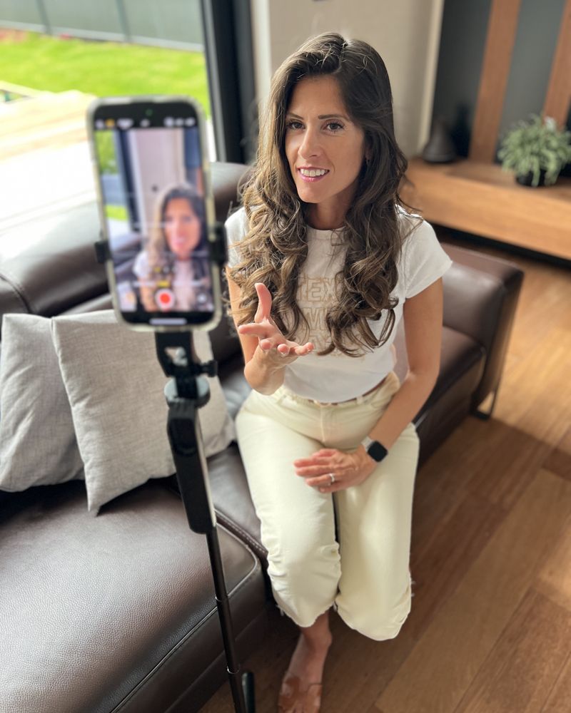 Gloria parle face à son téléphone sur trépied, en plein tournage